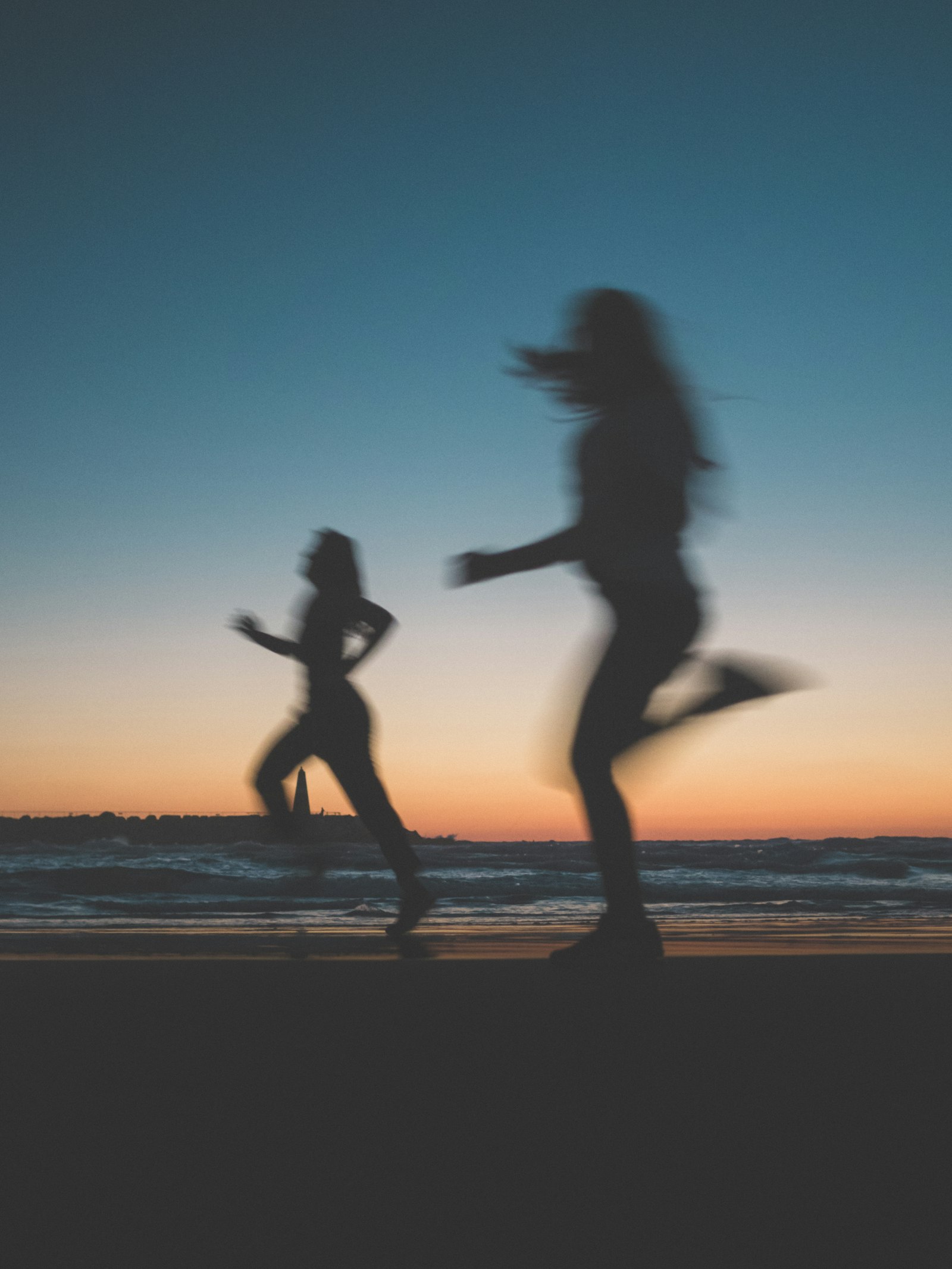 Members running along the shore at dusk