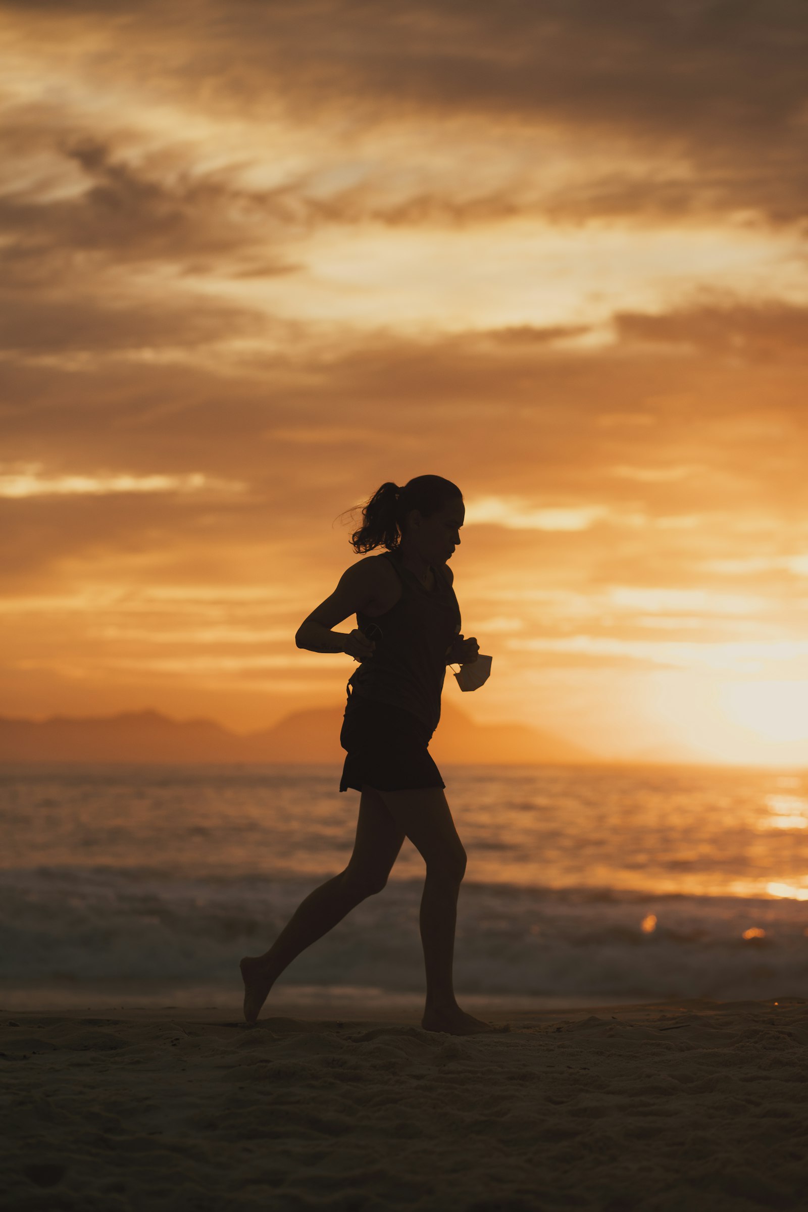 A member running at sunset on the beach